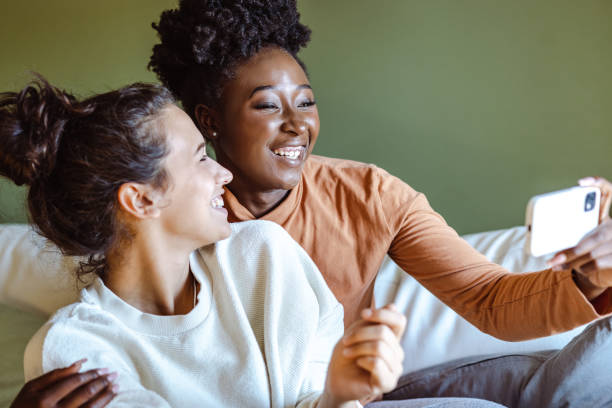 istock Female friends taking selfie at home 1438372911