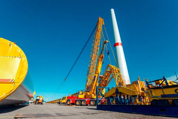 Construction site, driveway of building site. Building and assembling a construction windturbine by crane. Construction work at the windfarm, Wörrstadt, Germany. Energy crisis concept, wind turbine