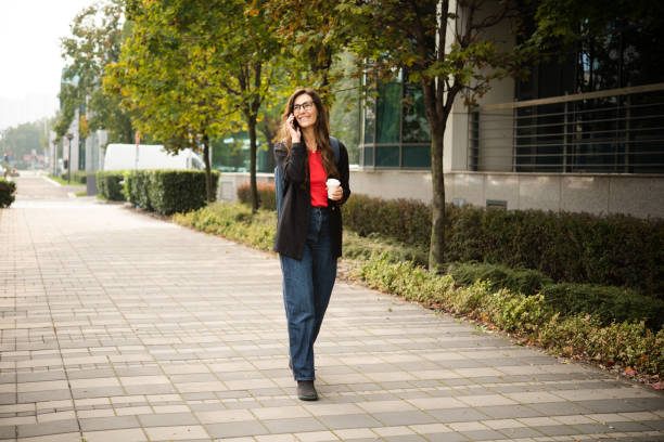 istock Happy woman coming back from work, enjoying coffee and telephoning 1438376672