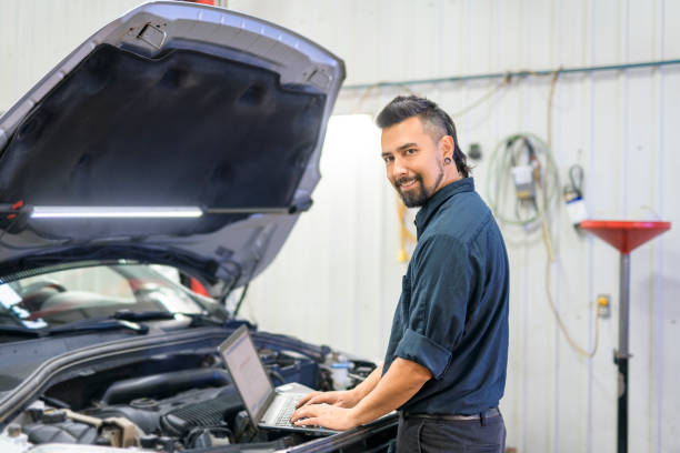 istock Handsome mechanic job in uniform working on car 1438376729