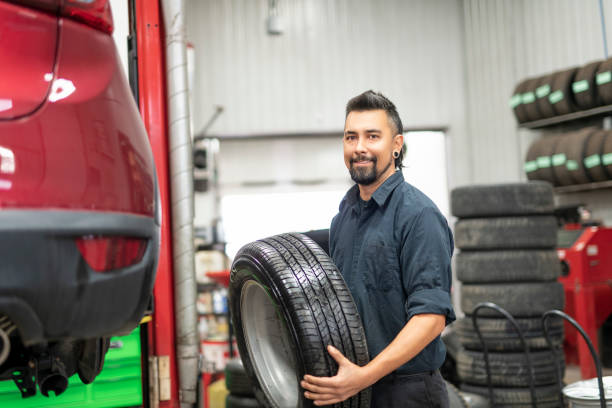 istock Nice and cool mechanic changing car tire at work 1438376747