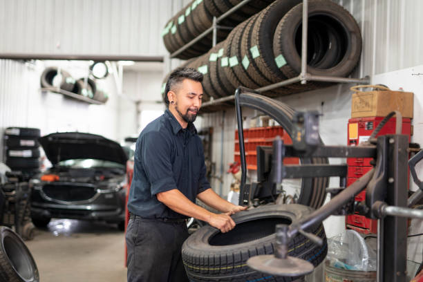 istock Nice and cool mechanic changing car tire at work 1438376896