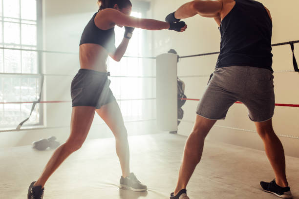 istock Young boxers fighting without gloves in a boxing ring 1438377176