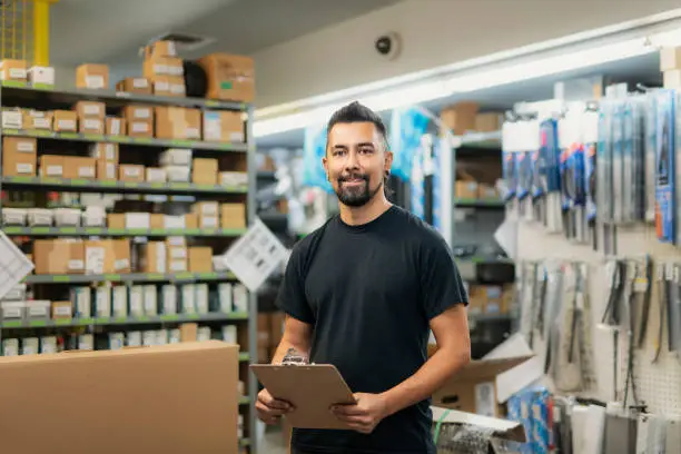 Photo of merchandiser checking products availibility for car repair