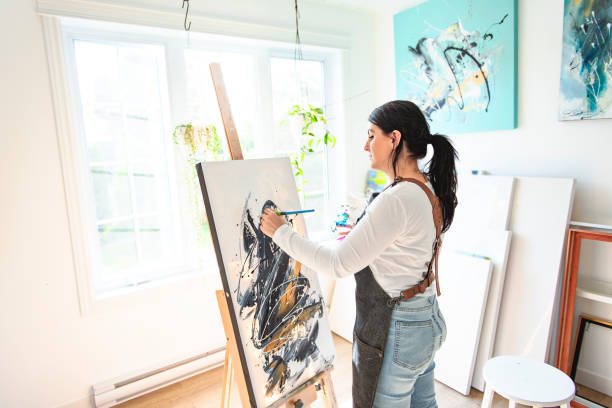 istock Portrait of a woman artist working on several art projects on her studio 1438385362