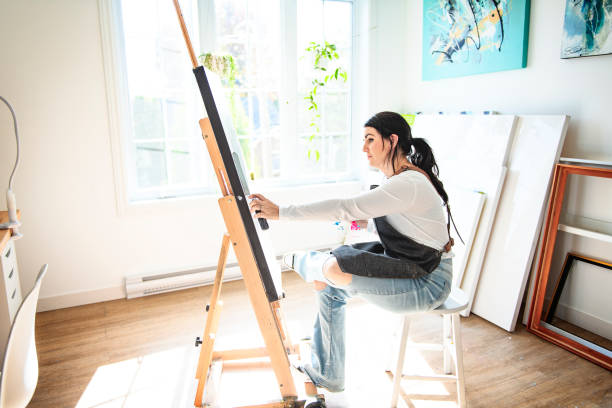istock Portrait of a woman artist working on several art projects on her studio 1438385365