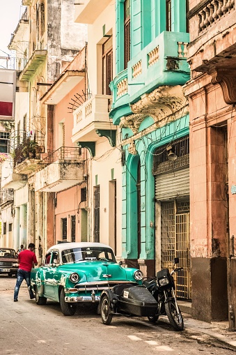 Havana, Cuba - July 18 2018 : A colorful view, a green house and his green car on the streets of old havana