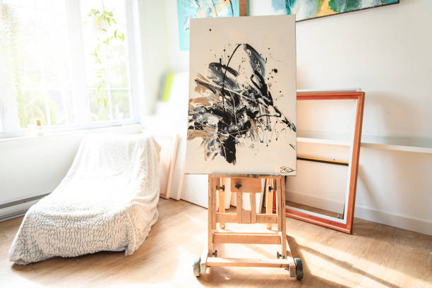 istock Artist's workshop. Canvas, paint, brushes, palette knife lying on the table. 1438385522