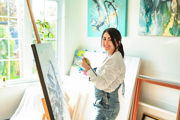 istock Portrait of a woman artist working on several art projects on her studio 1438385526