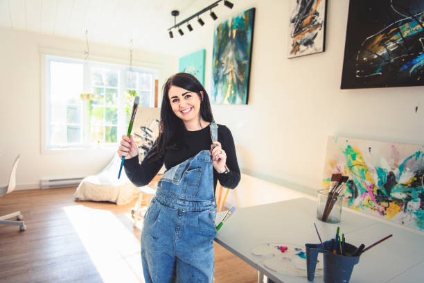 istock Portrait of a woman artist working on several art projects on her studio 1438385582
