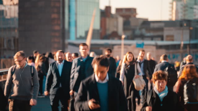 Time lapse of Crowded Commuter people walking in rush hour on the London bridge in downtown district of London, United Kingdom