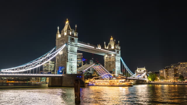 Time lapse of Tower bridge Lifting the drawbridge for nautical vessel passing through the river thamesat night in London United Kingdom,