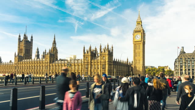 Time lapse of Crowded people Tourism walking and see sighting in Big Ben with House of Parliament and Westminster Bridge of London United Kingdom