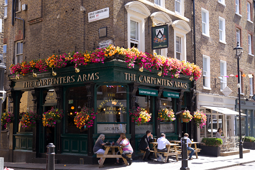 Beautiful decorated pub named Carpenters Arms at Marble Arch London on a sunny summer noon. Photo taken August 5th, 2022, London, United Kingdom.