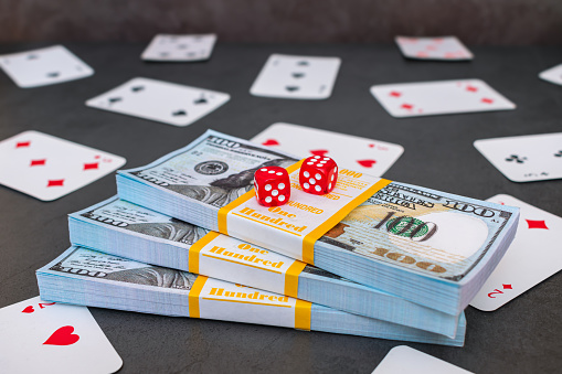 Cards, money and dice on the gaming table in the casino