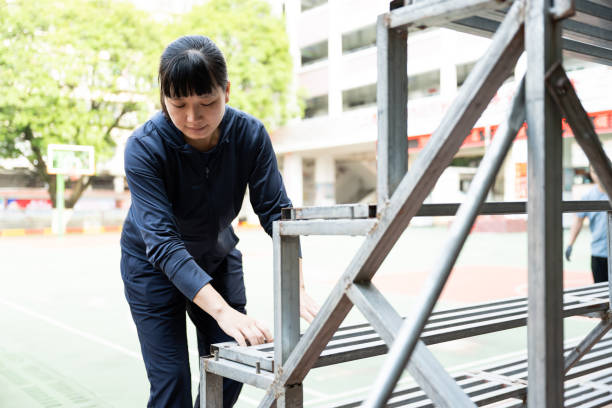 istock A female worker was installing iron parts 1438387654