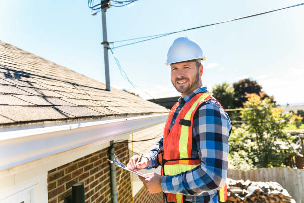 istock man with hard hat standing on steps inspecting house roof 1438389420