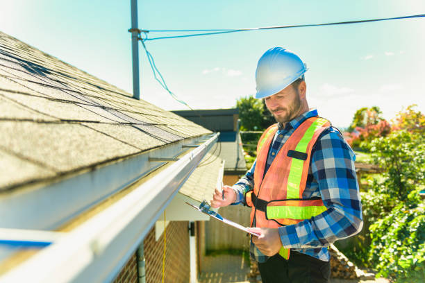 istock man with hard hat standing on steps inspecting house roof 1438389450