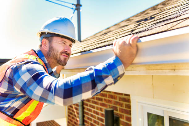 istock man with hard hat standing on steps inspecting house roof 1438389460