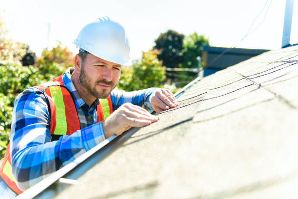 istock man with hard hat standing on steps inspecting house roof 1438389527