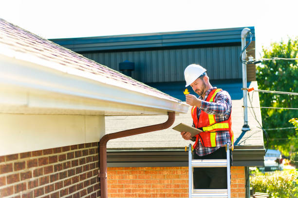 istock man with hard hat standing on steps inspecting house roof 1438389548