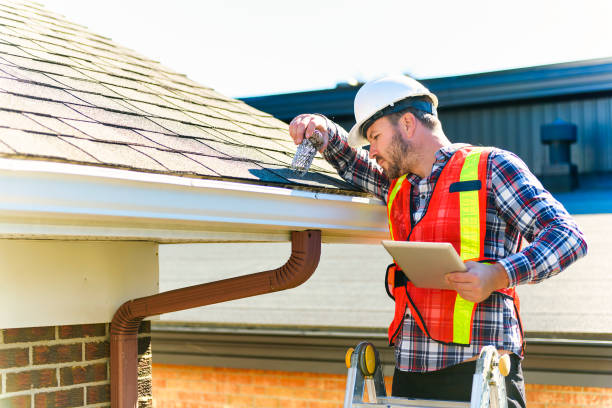 istock man with hard hat standing on steps inspecting house roof 1438389549