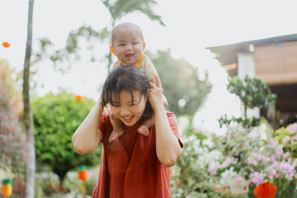 istock Asian mother and baby boy bonding time at backyard during evening 1438389744
