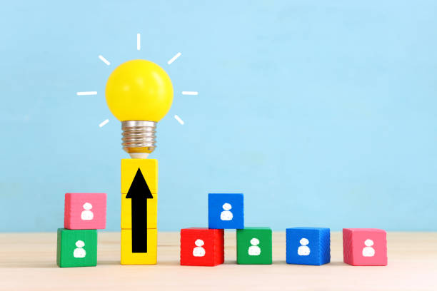 istock Education and human resource concept image. Creative idea and innovation. light bulb metaphor over blue background, wooden cubes and people icons 1438390297