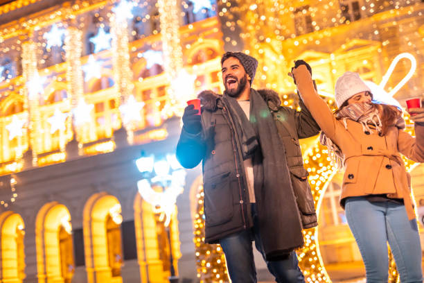 istock Couple dancing and drinking hot mulled wine while celebrating New Year outdoors 1438390411