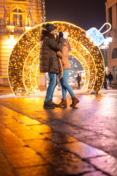 istock Couple hugging in city square for Christmas 1438390477