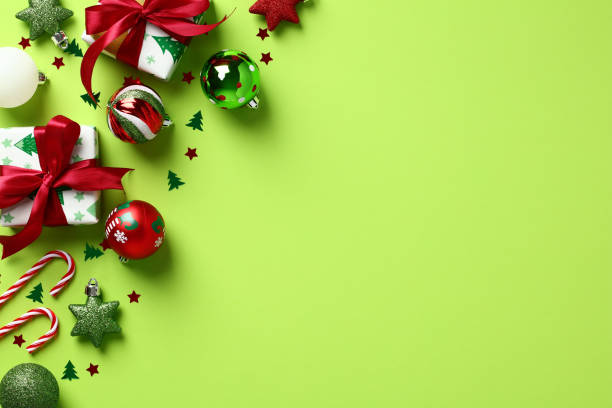 istock Christmas flat lay composition with gift boxes, baubles, festive decorations on light green background. 1438390524