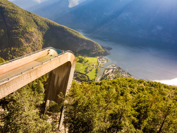 tourist enjoying fjord view on stegastein viewpoint norway - aurlandfjord imagens e fotografias de stock