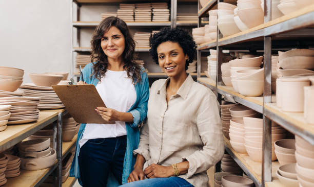 istock Two happy young ceramists working together in their shop 1438393605