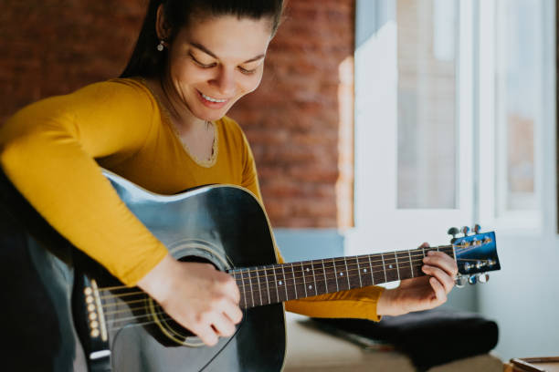 istock Woman taking guitar lessons 1438393789