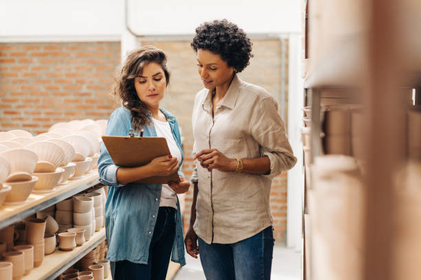 istock Two young businesswomen working together in their ceramic store 1438393793