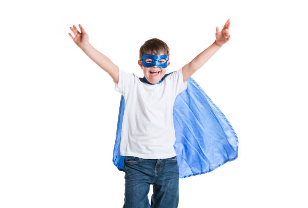 A super hero child boy posing on studio white background