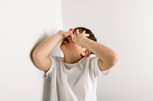 istock sad and depress child boy posing on studio white background 1438394012