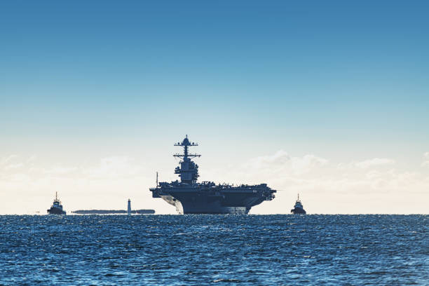 Navy Aircraft Carrier Navy aircraft carrier enters a harbour after offshore training exercises. warship stock pictures, royalty-free photos & images