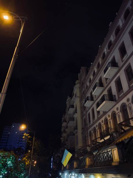 istock street at night with Ukrainian flag 1438394396