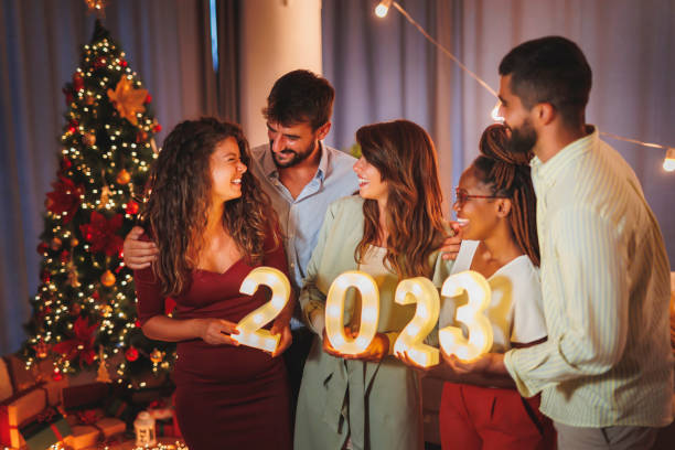 istock Friends holding illuminative numbers 2023 while celebrating New Year 1438395204