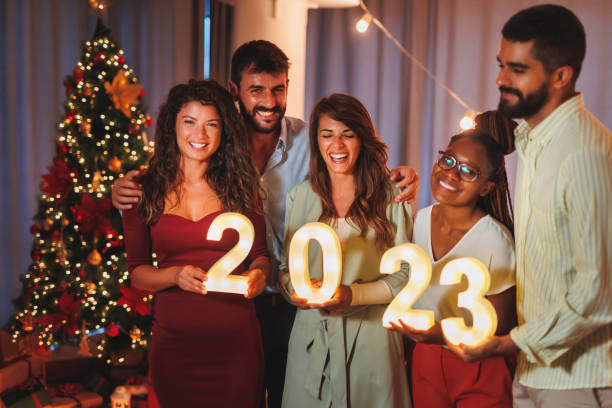 istock Friends holding illuminative numbers 2023 representing upcoming New Year 1438395276