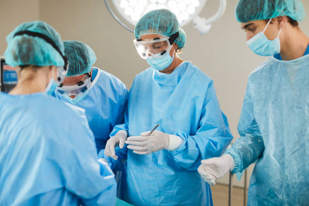 istock Scrub nurse holding forceps is ready to assist surgeon 1438395424