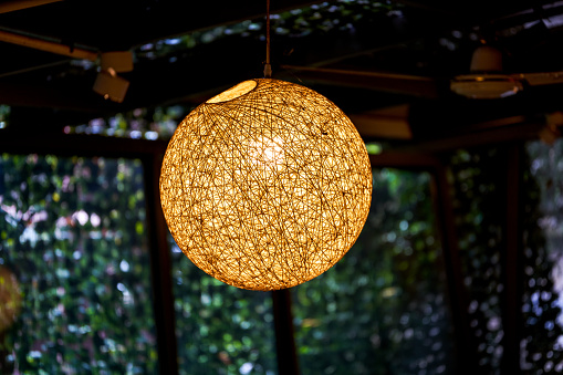 Close-up of round rattan chandelier indoors