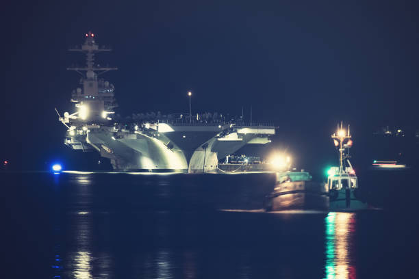 American aircraft carrier anchored in a harbour after offshore training exercises.