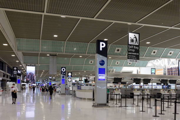 Narita International Airport in Japan Narita, Japan - September 9, 2022 : People at a check-in area in a departure hall at Narita International Airport in Narita, Chiba Prefecture, Japan. Narita International Airport is an international airport serving the Greater Tokyo Area. narita japan stock pictures, royalty-free photos & images