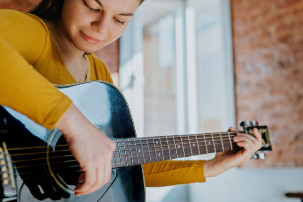 istock Woman taking guitar lessons 1438396808