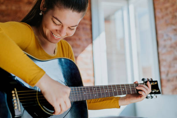 istock Woman taking guitar lessons 1438397466
