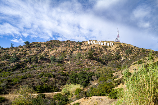 A photo of the iconic Hollywood sign which overlooks Los Angeles, CA.  The sign is perched atop Mount Lee in the Beachwood Canyon area of the Santa Monica mountains.