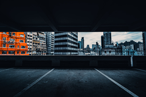 Interior of parking garage with car and vacant parking lot in parking building