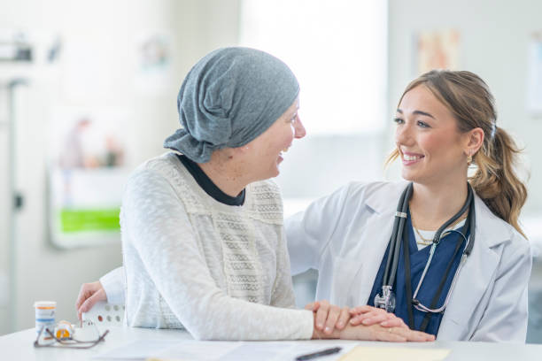 oncologist comforting a cancer patient - medical exam doctor patient adult imagens e fotografias de stock